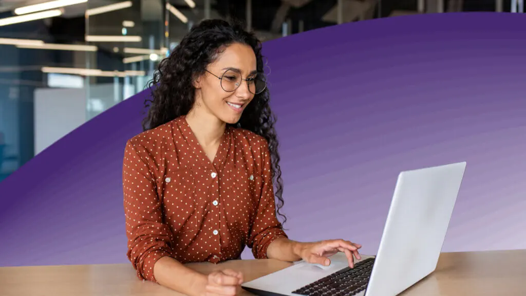 Successful woman working inside office with laptop.
