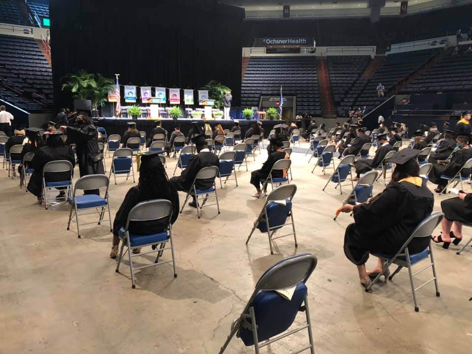 A diverse crowd seated in an arena, engrossed in an event.