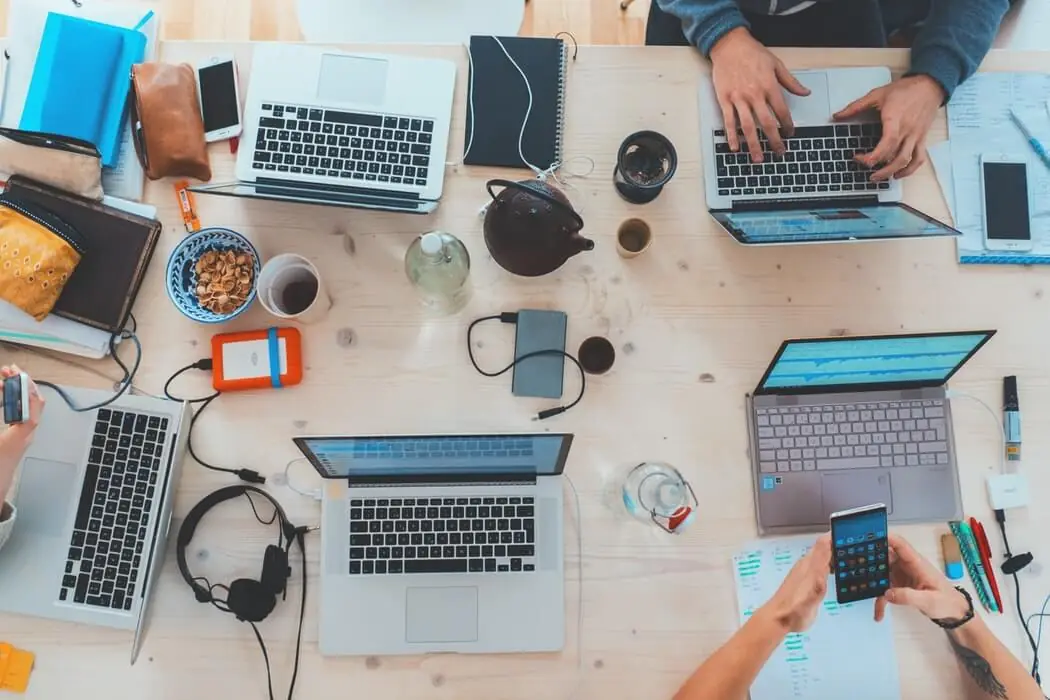 People working on laptops at a table.