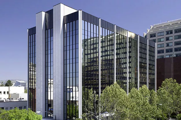 A sprawling office building with numerous windows.