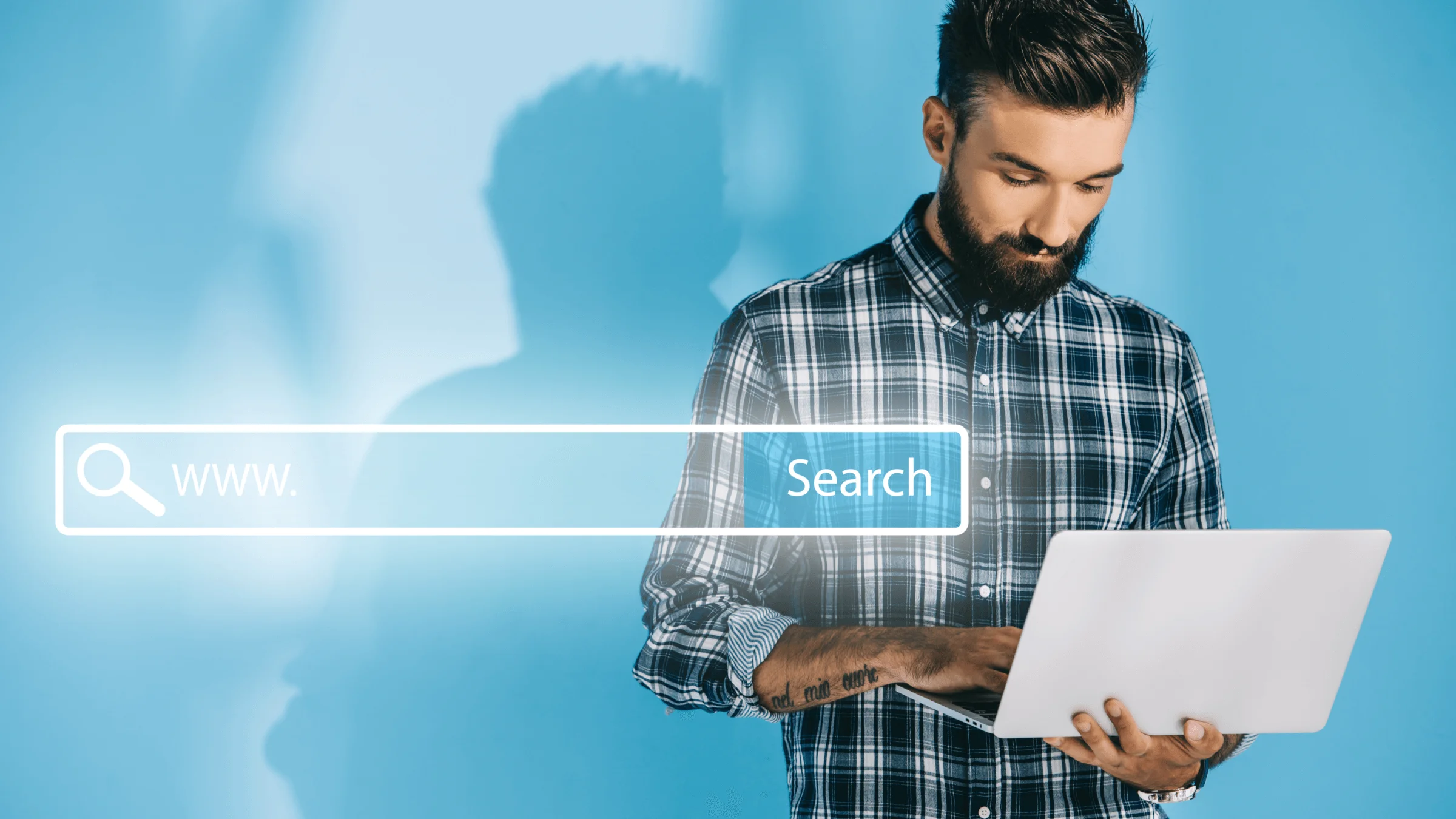 A man searches the web one his laptop as the web search is superimposed over him.