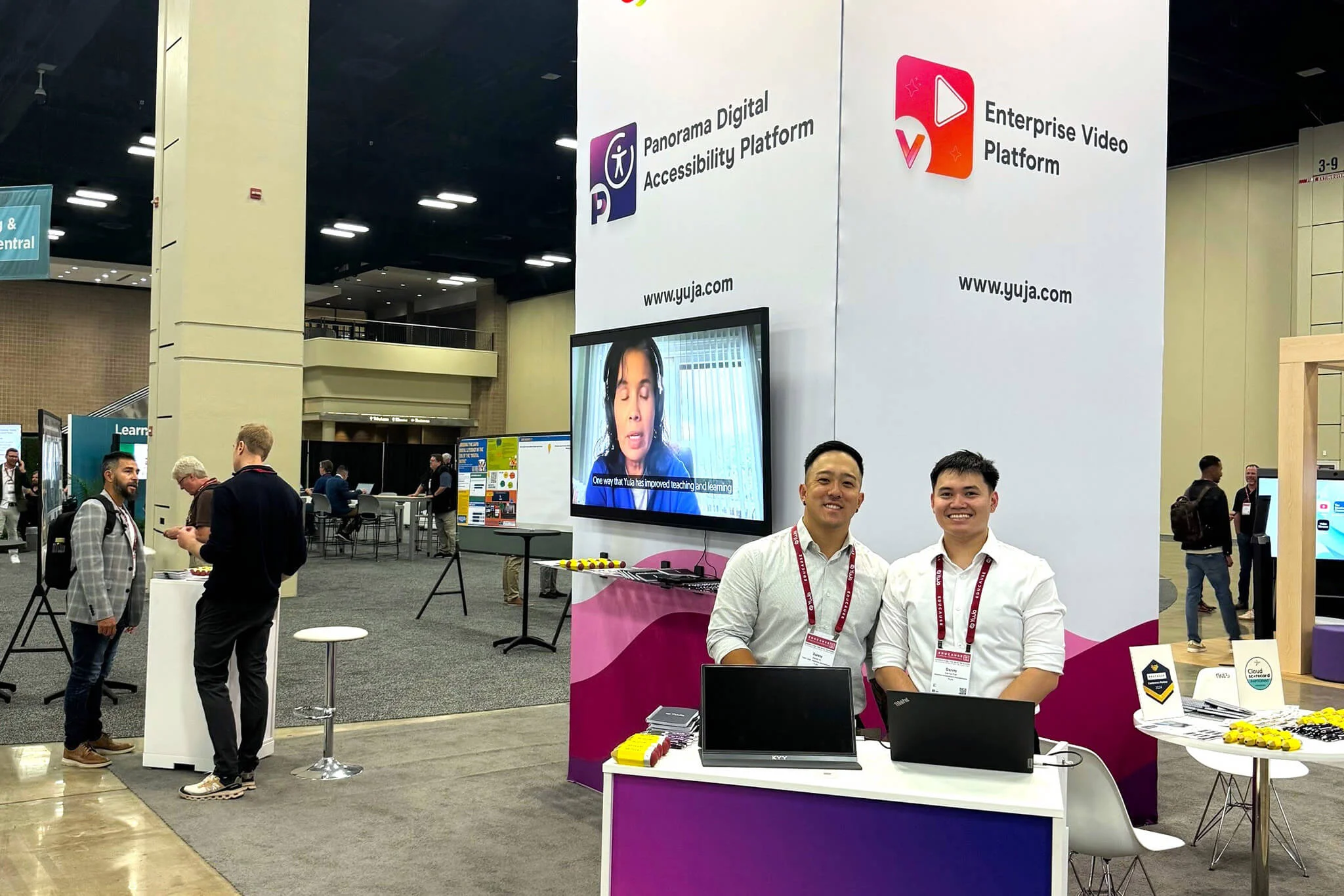 YuJa's booth displaying a laptop and a team member.