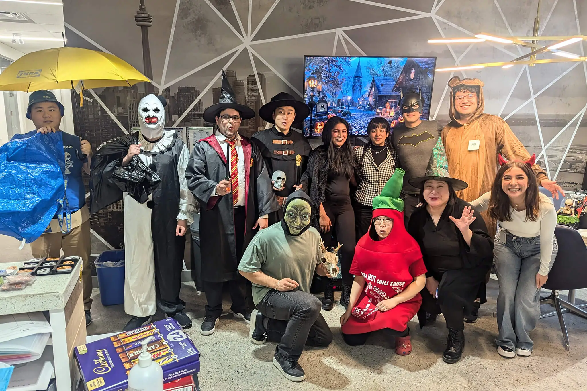 YuJa team members celebrating in creative costumes during a festive event.