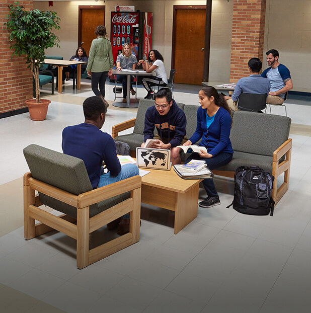 Students studying at tables in the library.