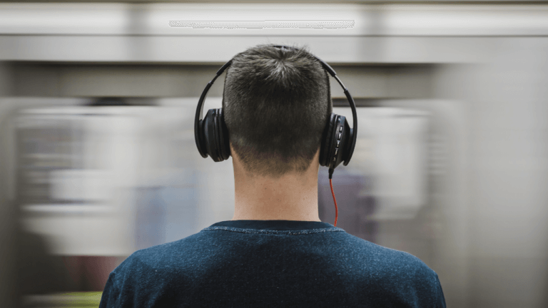 a man who is visually impaired listening to headphones.