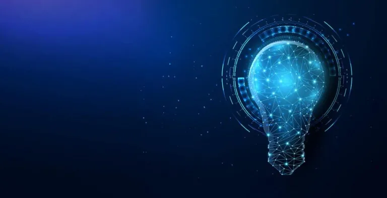 Blue lightbulb on dark blue background.