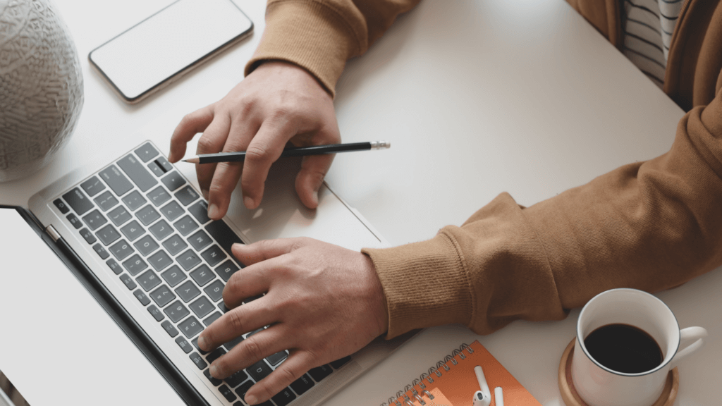 Hands on a computer keyboard.