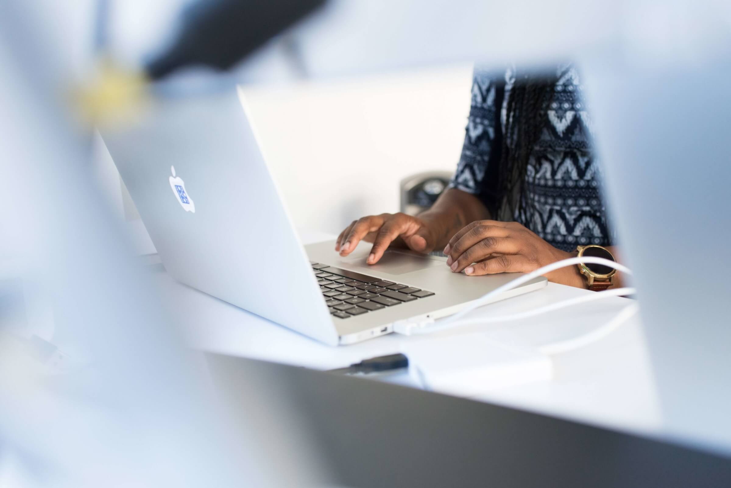 A person typing on a laptop computer.