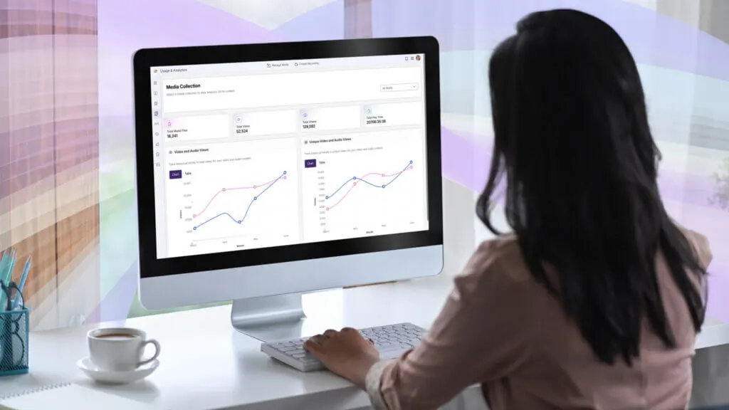 A woman using the YuJa Enterprise Video Platform on her home computer.