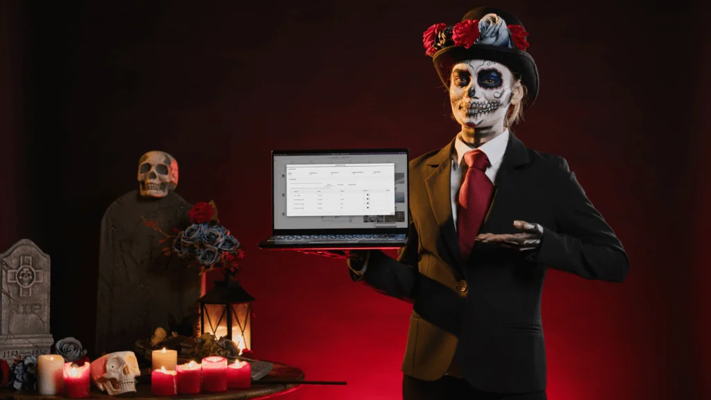A woman in a Halloween costume in a spooky setting holds a laptop featuring the ability to configured peripheral devices when using Software Capture.