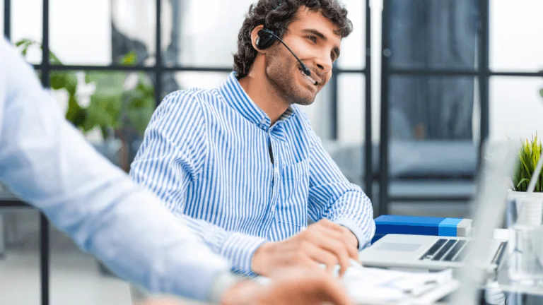 A man in an office with a headset on