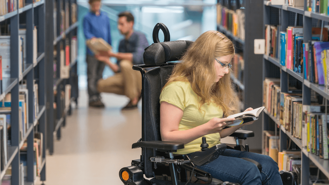 A women in a wheelchair in a library.
