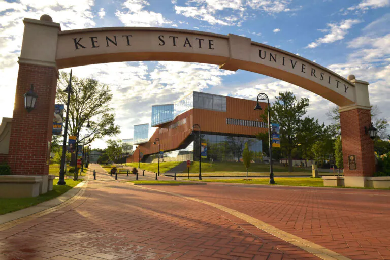 Main entrance archway to Kent State University in Kent, Ohio, framing the modern John Elliot Center for Architecture and Environmental Design.