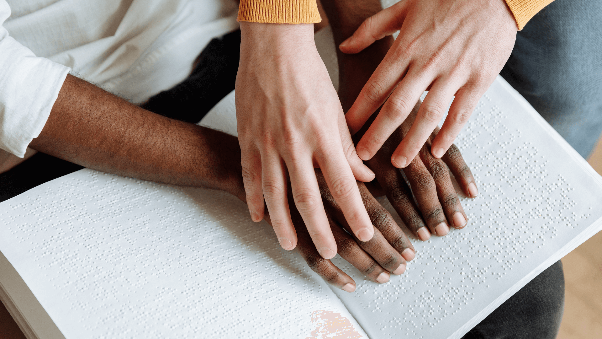 A teacher helping a student with braille