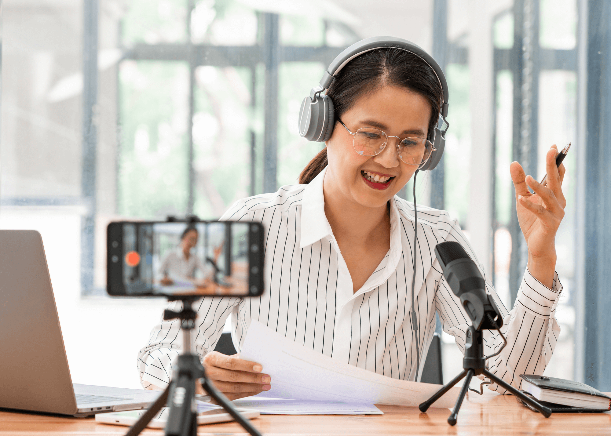 Woman wearing headphones records with professional headphones and microphone.