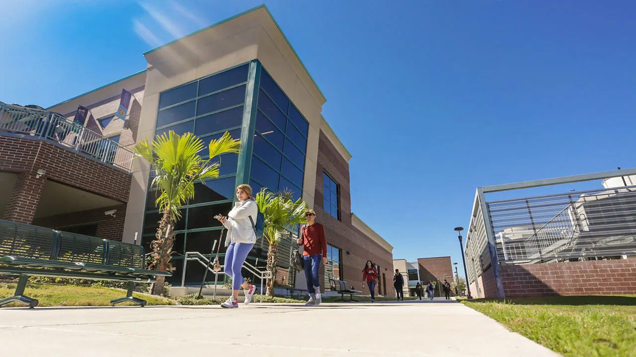A low view of students walking between campus buildings at South Texas College’s Pecan Campus in McAllen, Texas.