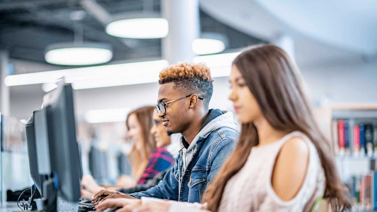 A group of students working on computers in a library.