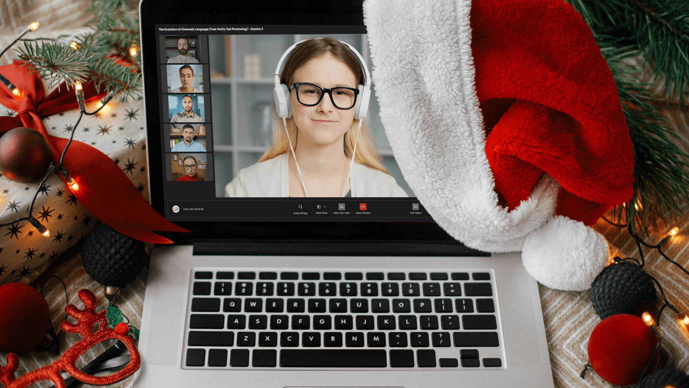 The new Verity Live Proctoring Media Player open in a laptop, which sits on a festive table. A Santa hat hangs off one corner.