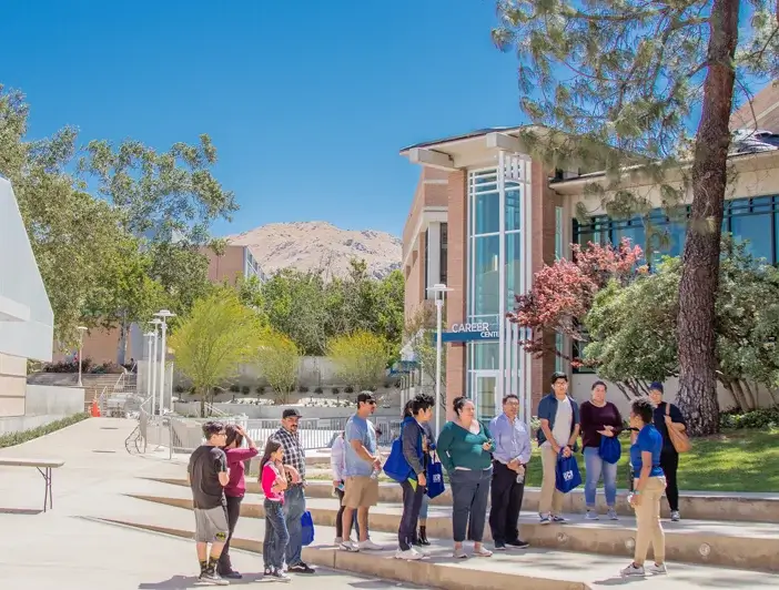 A group of people in front of Johnson County Community College building.