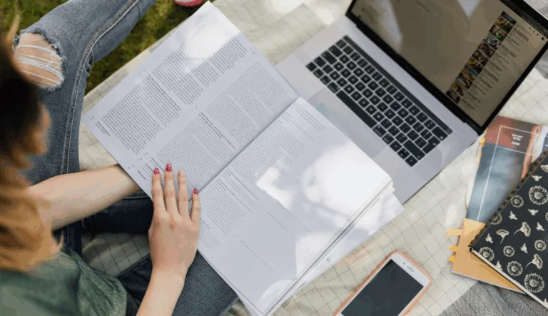 A student is looking at a page of orginized videos on her laptop.