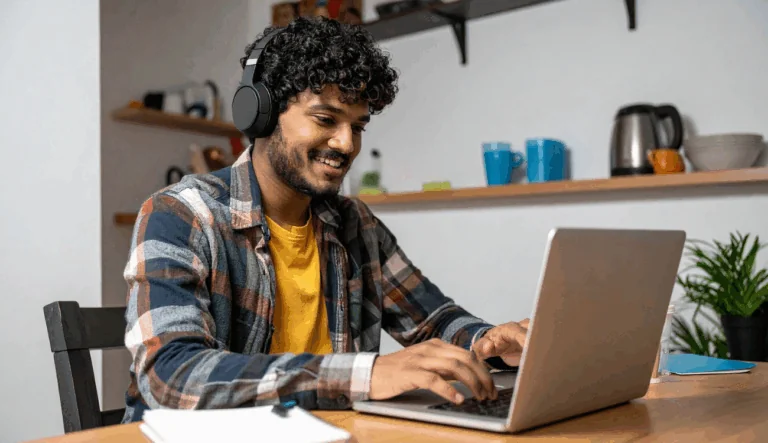 A student is listening to a class room assignment on a laptop.