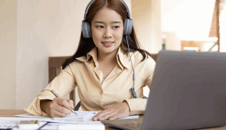 A young lady attends an online conference on her laptop.