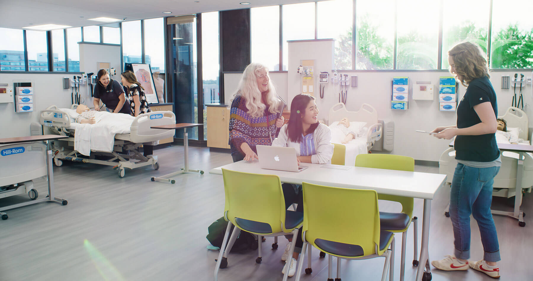 A group of people sitting around a table at Clarkson College.