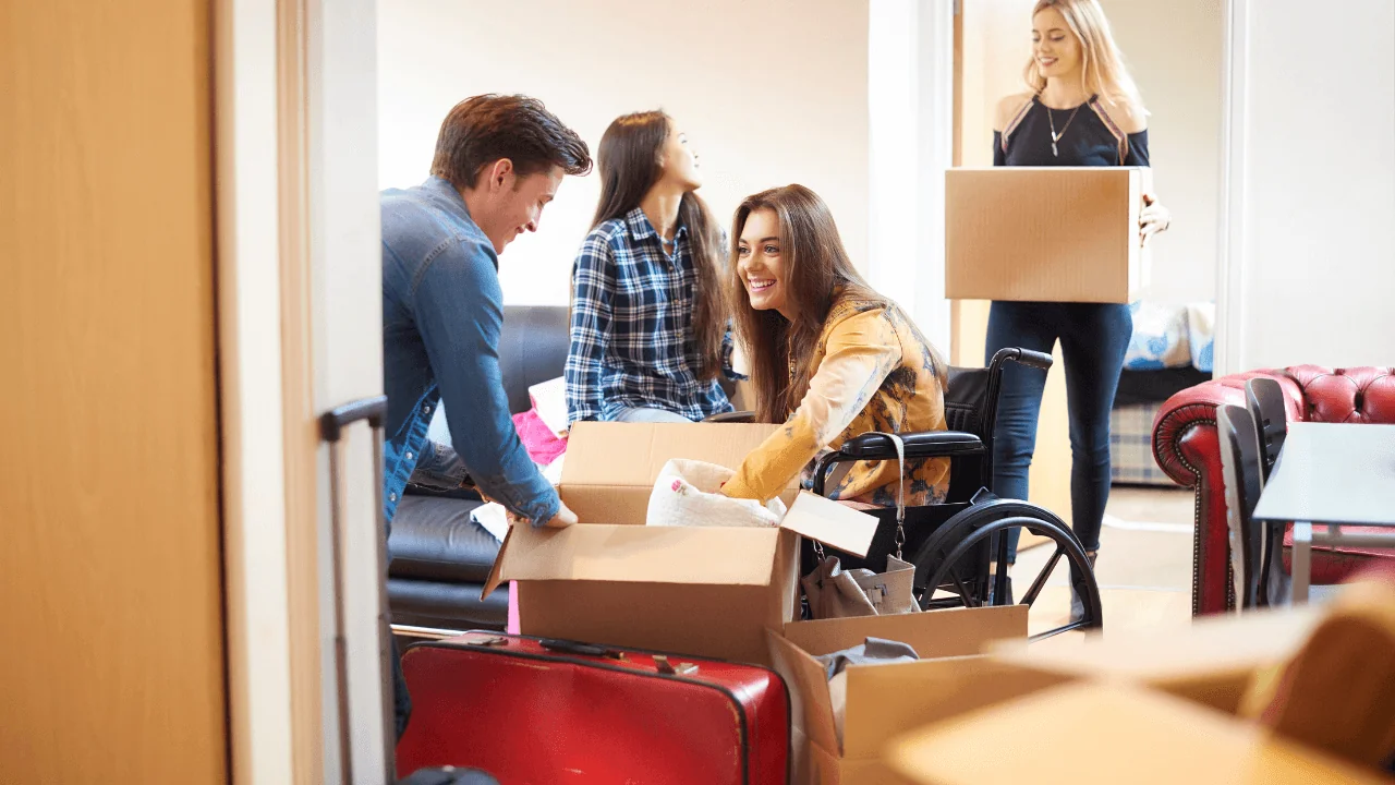 College-aged students of all abilities crowd around a an empty box.