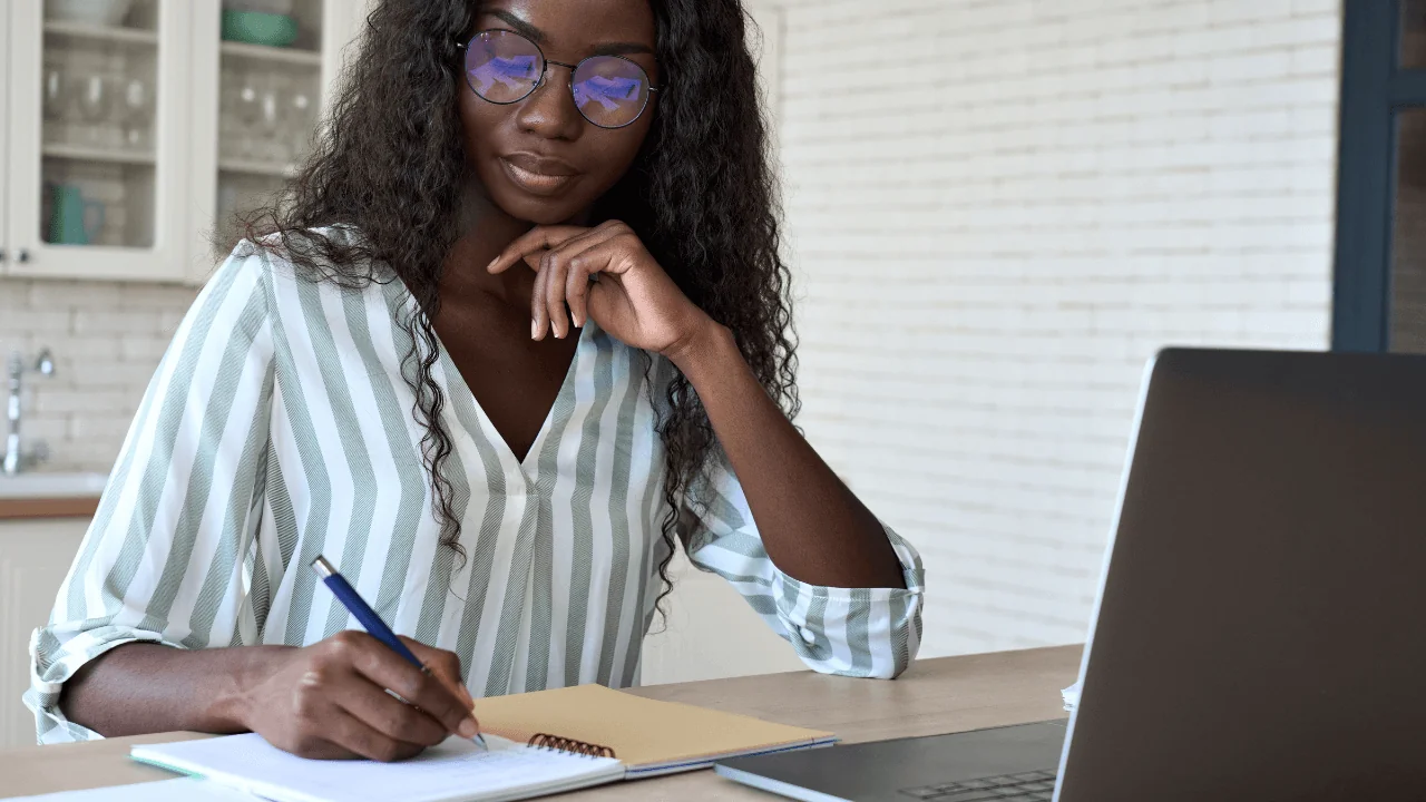 Young woman looks at a computer screen.