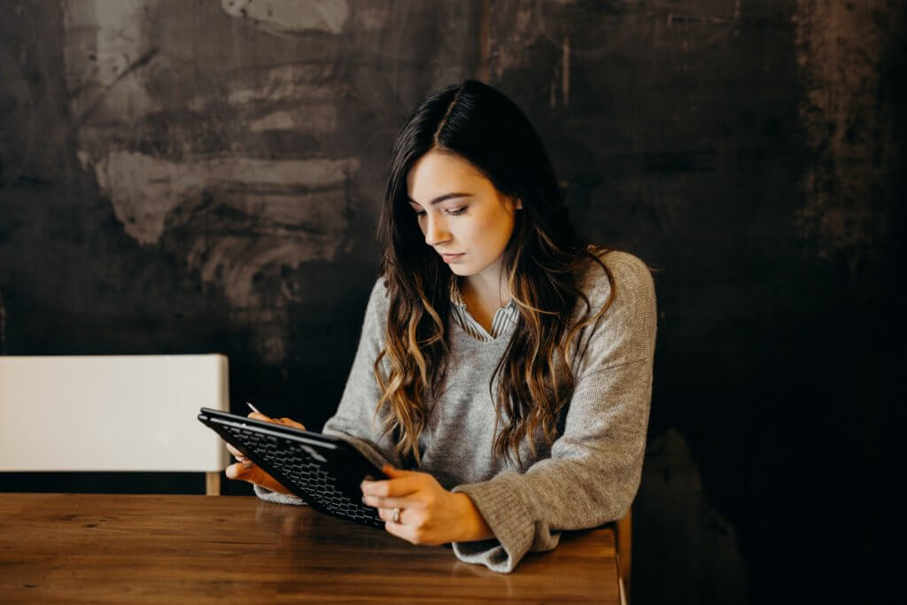 Woman looking at tablet.