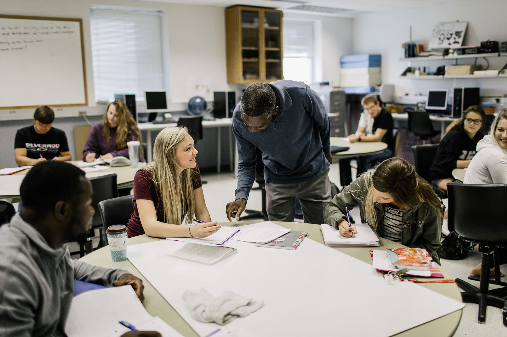 A diverse group of students sitting at desks in a classroom.