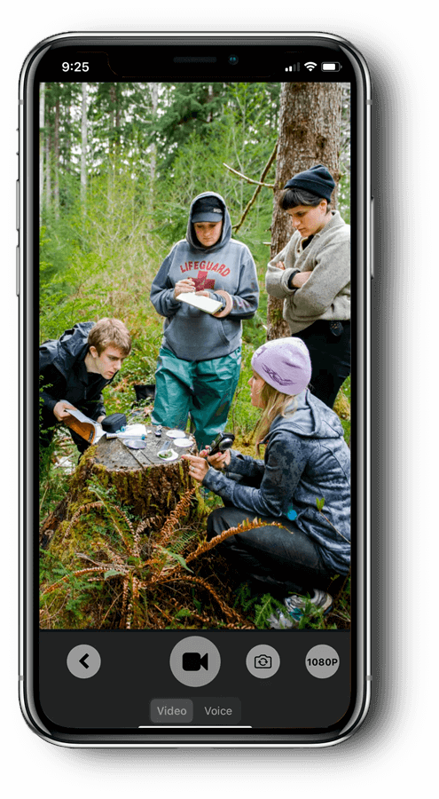 A video of students outdoors is being recorded on a cell phone.