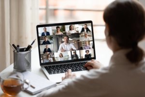 woman looking at video conference on a laptop