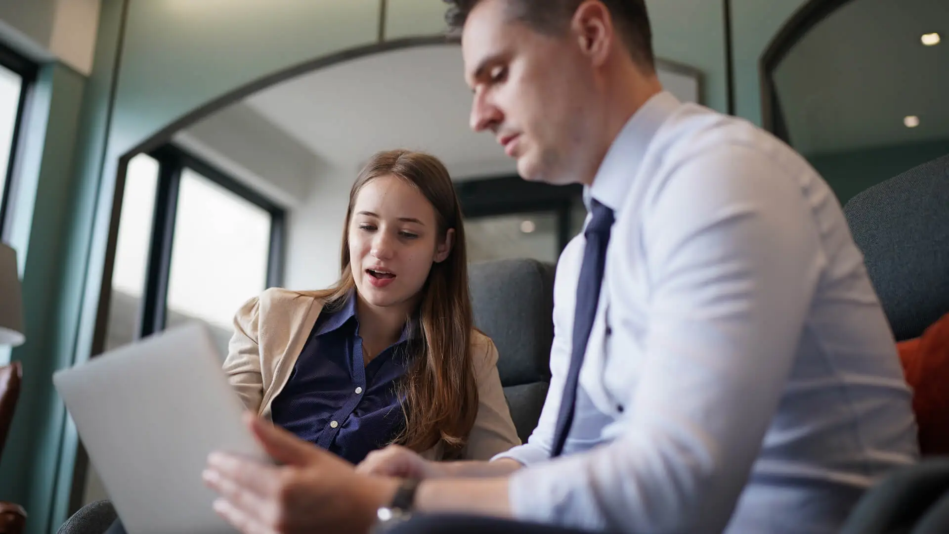 A close up of a man and a woman having a discussion.