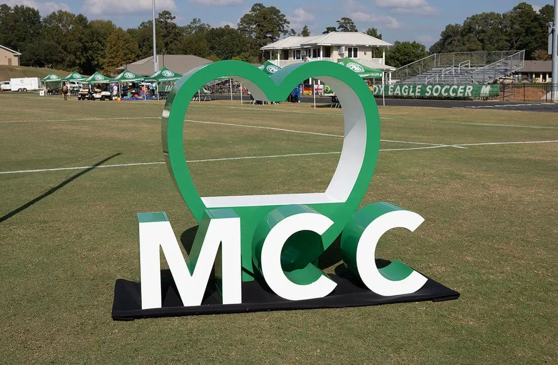 MCC inside a heart displayed on an athletic field                .