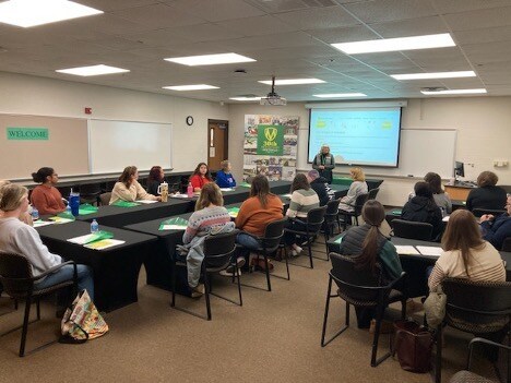 A classroom of students listens to a lecture.