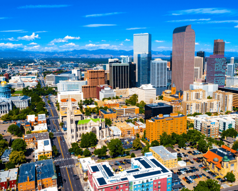 A city skyline with towering buildings against a clear blue sky.