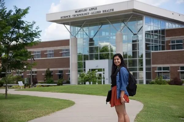  A student stands in front of a building on the Motlow State campus              .