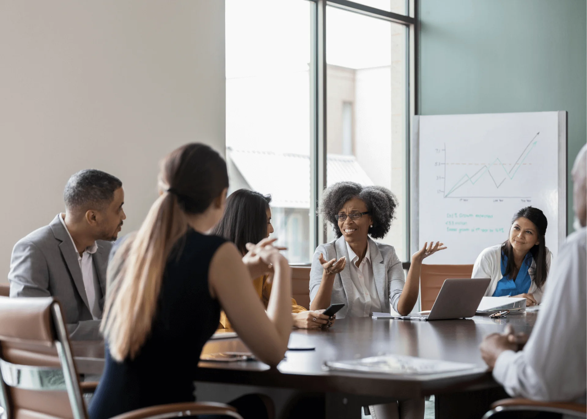 A group of people gathered around a table in a business environment.