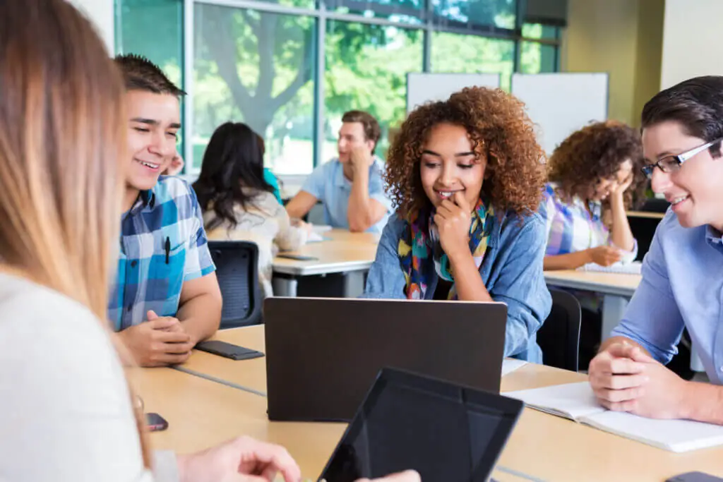 Classmates studying together in high school or college classroom