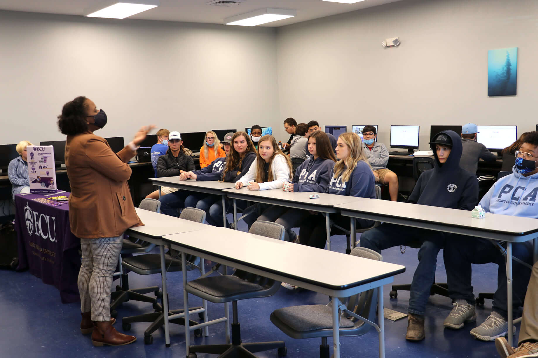 A woman presenting to students in a classroom at Pamlico Community College.