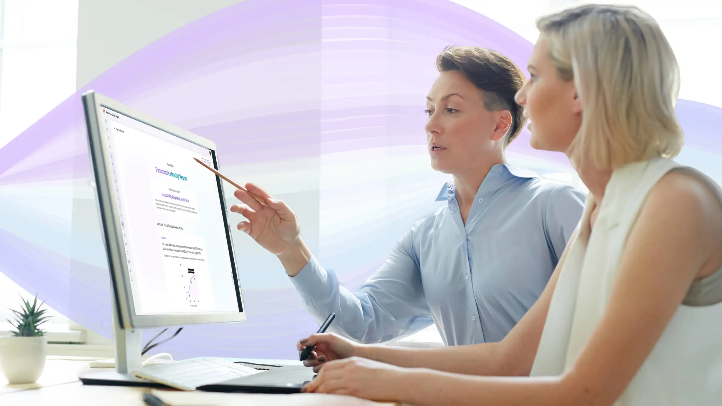 Two women use a computer featuring the Panorama usage report.