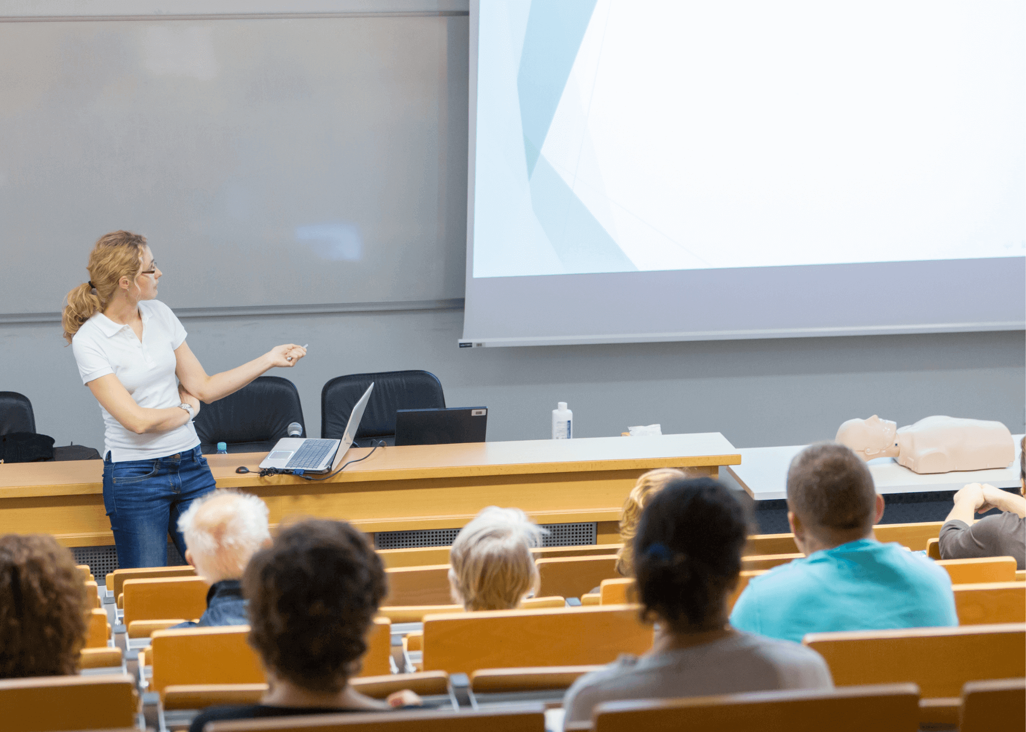 A woman giving a lecture in a lecture hall.