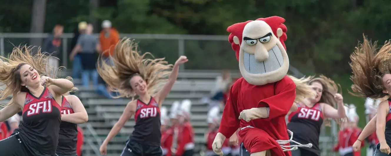 The Saint Francis University mascot and cheerleaders at a game.