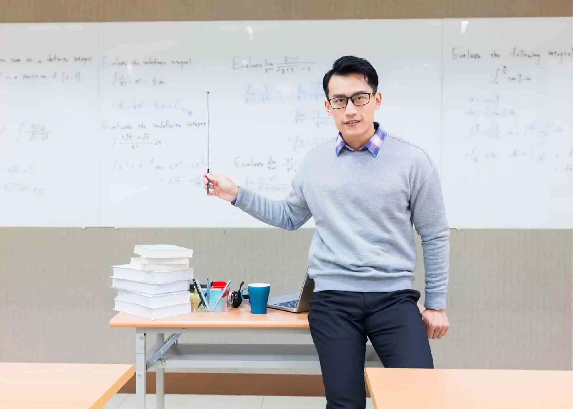 A man standing in front of a whiteboard presenting or lecture.