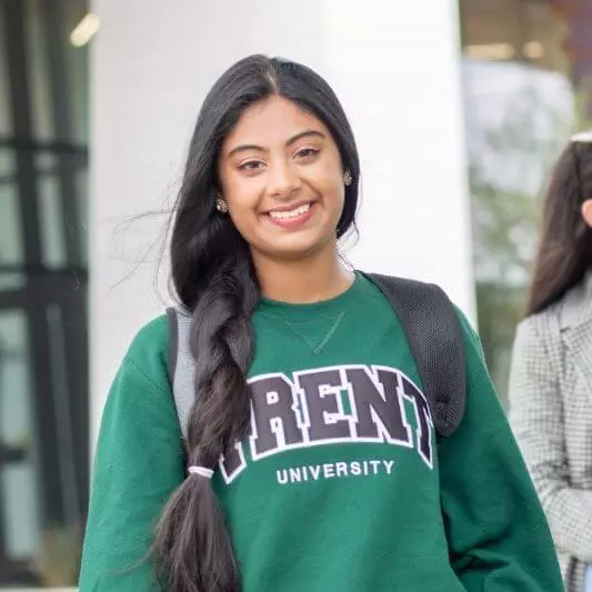 A women in a green Trent University sweatshirt