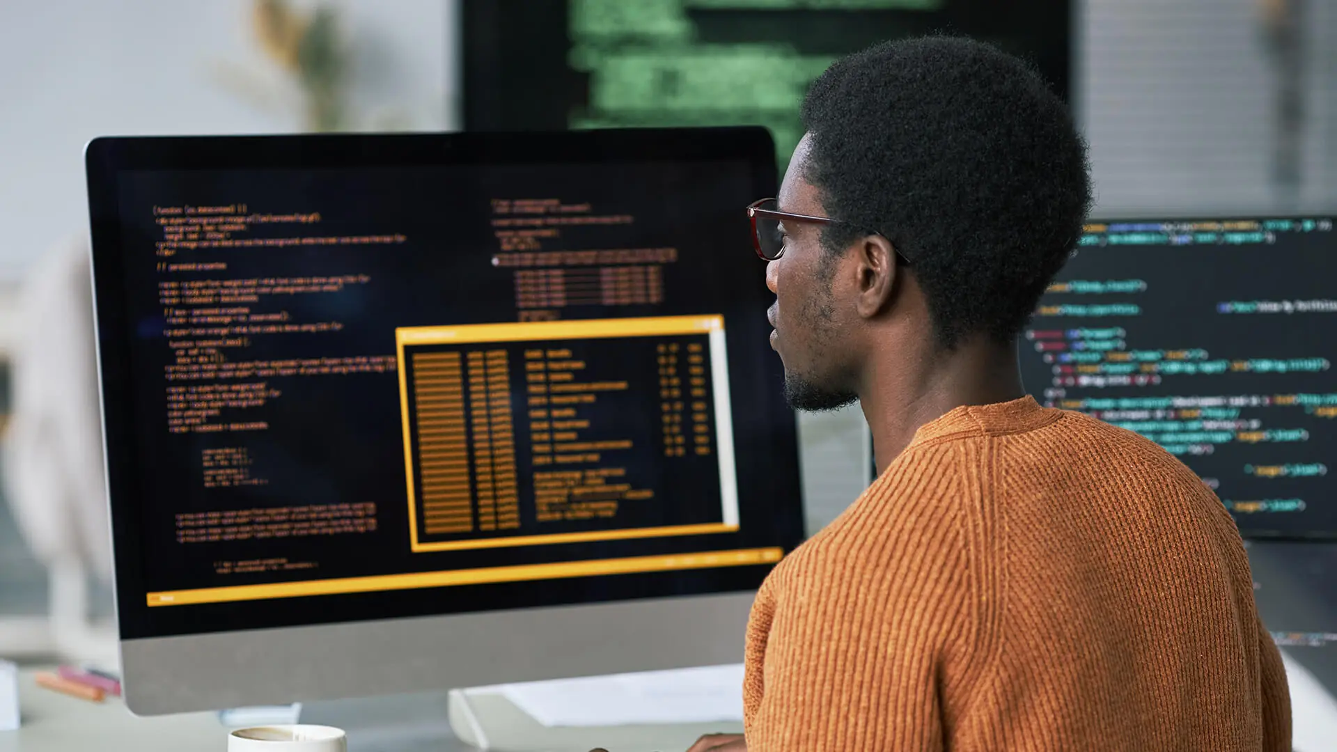A man goes over complex data on his computer.