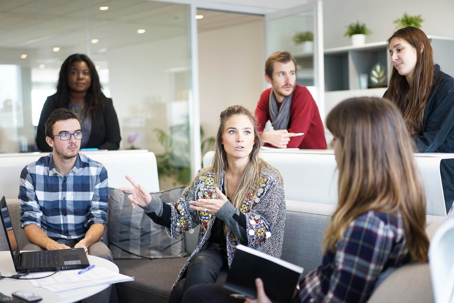 A group of professionals collaborate in an office environment.