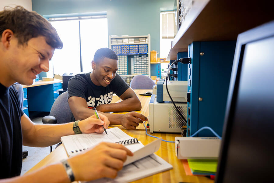 Two students collaborating on a project in a laboratory.