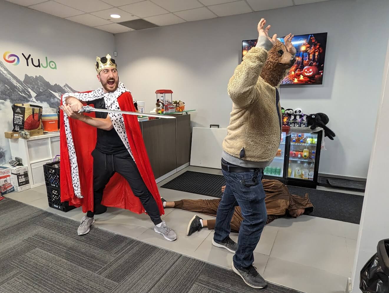 Two team members dressed as a king and bear in the office.